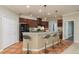 Modern kitchen with dark wood cabinets, breakfast bar, and stainless steel appliances at 8817 Crystal Creek Ct, Land O Lakes, FL 34638