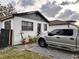 House with gray siding and a silver pickup truck parked in the driveway at 3102 W Leroy St # A, Tampa, FL 33607