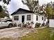 White house with gray trim, a driveway, and potted plants at 3102 W Leroy St # A, Tampa, FL 33607
