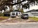 Two-vehicle driveway with a house and large tree at 3102 W Leroy St # A, Tampa, FL 33607