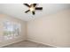 Bedroom with carpet floors, ceiling fan, and window at 5000 Culbreath Key Way # 1-203, Tampa, FL 33611
