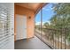 Private screened balcony overlooks lush landscape and partial water view at 5000 Culbreath Key Way # 1-203, Tampa, FL 33611