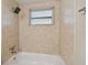 Updated bathroom with a bathtub and shower, featuring tile walls at 3525 Umber Rd, Holiday, FL 34691