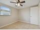 Simple bedroom with ceiling fan and tile floors at 3525 Umber Rd, Holiday, FL 34691