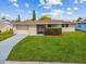 Single story home with a well-manicured lawn at 3525 Umber Rd, Holiday, FL 34691