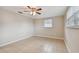 Bright bedroom with tile floors and ceiling fan at 3525 Umber Rd, Holiday, FL 34691