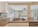 Modern kitchen with granite countertops and stainless steel sink at 3525 Umber Rd, Holiday, FL 34691
