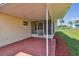 Covered patio and spacious backyard with wooden fence at 3525 Umber Rd, Holiday, FL 34691
