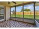 Enjoyable screened porch with tile floor and backyard view at 3525 Umber Rd, Holiday, FL 34691