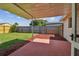 Covered patio and fenced backyard with grassy area at 3525 Umber Rd, Holiday, FL 34691