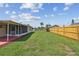 Spacious backyard with a grassy area and wooden fence at 3525 Umber Rd, Holiday, FL 34691