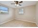 Bright bedroom featuring ceiling fan, tile flooring, and window blinds at 3525 Umber Rd, Holiday, FL 34691