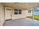 Covered entryway with white door and window, offering curb appeal at 3525 Umber Rd, Holiday, FL 34691