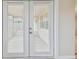 White French door leading to the backyard patio at 3525 Umber Rd, Holiday, FL 34691