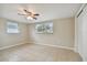 Spacious bedroom with tile floors and ceiling fan at 3525 Umber Rd, Holiday, FL 34691