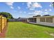 Large backyard with grassy lawn and wooden fence at 3525 Umber Rd, Holiday, FL 34691