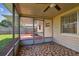 Bright screened porch with tiled floor and access to backyard at 3525 Umber Rd, Holiday, FL 34691