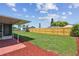 Large backyard with grassy lawn and wooden fence at 3525 Umber Rd, Holiday, FL 34691