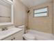 Clean bathroom with tile flooring, a shower/tub combo, and a vanity with a mirror at 3525 Umber Rd, Holiday, FL 34691
