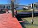 Red wooden dock with boat lift and waterfront access at 11365 5Th E St, Treasure Island, FL 33706