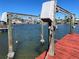 Boat lift on a red wooden dock at 11365 5Th E St, Treasure Island, FL 33706