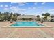 Refreshing community pool with brick patio and clubhouse in background at 3825 Pompano Se Dr, St Petersburg, FL 33705