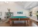 Game room features a pool table, seating area, and shelves for games at 3825 Pompano Se Dr, St Petersburg, FL 33705