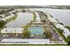 Aerial view of community with tennis courts and water features at 3825 Pompano Se Dr, St Petersburg, FL 33705