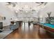 Spacious community room with pool table, seating, and dining area at 3825 Pompano Se Dr, St Petersburg, FL 33705