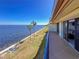 The condo balcony offers amazing views with palm trees and coastline visible from sliding glass doors at 7520 Sunshine Skyway S Ln # 210, St Petersburg, FL 33711