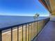 Balcony overlooking a beautiful waterfront view with palm trees and clear blue sky at 7520 Sunshine Skyway S Ln # 210, St Petersburg, FL 33711