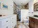 Bathroom featuring tiled shower, a modern vanity, and updated fixtures at 7520 Sunshine Skyway S Ln # 210, St Petersburg, FL 33711