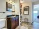 Bathroom with a granite vanity, decorative mirror, and tiled floor, leading to bedroom with water view at 7520 Sunshine Skyway S Ln # 210, St Petersburg, FL 33711