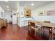 Open-concept dining room with wood floors, stylish furnishings, and easy access to the kitchen at 7520 Sunshine Skyway S Ln # 210, St Petersburg, FL 33711