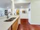 Well-lit view of kitchen with stainless steel sink, wood cabinets, and an open layout at 7520 Sunshine Skyway S Ln # 210, St Petersburg, FL 33711
