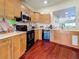 Bright kitchen features wood cabinets, modern appliances, and a pass-through window with a beautiful water view at 7520 Sunshine Skyway S Ln # 210, St Petersburg, FL 33711