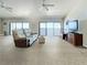 Spacious living room with sliding glass doors leading to a balcony with water views at 7520 Sunshine Skyway S Ln # 210, St Petersburg, FL 33711