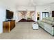 Bright, open living room showing connecting spaces with neutral carpet and white walls at 7520 Sunshine Skyway S Ln # 210, St Petersburg, FL 33711