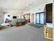 Bright living room with neutral carpeting, ceiling fans, and access to other rooms at 7520 Sunshine Skyway S Ln # 210, St Petersburg, FL 33711