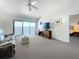 A cozy living room with balcony access overlooking the ocean and neutral decor at 7520 Sunshine Skyway S Ln # 210, St Petersburg, FL 33711