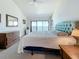 Spacious main bedroom featuring a large bed, water views, and a private balcony entrance at 7520 Sunshine Skyway S Ln # 210, St Petersburg, FL 33711