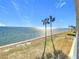 A stunning waterfront view showcases palm trees lining the coast with the sparkling water at 7520 Sunshine Skyway S Ln # 210, St Petersburg, FL 33711