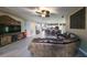 Open-concept living area with a leather sofa, TV, and seamless flow into the kitchen, perfect for entertaining at 805 Seminole Sky Dr, Ruskin, FL 33570