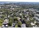 Aerial view of a community with houses and lush green trees at 1106 Lennox W Rd, Palm Harbor, FL 34683