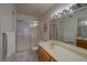 Clean bathroom with a large mirror, single sink vanity, and shower/tub combo at 1106 Lennox W Rd, Palm Harbor, FL 34683