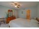 Bedroom with ceiling fan, dresser, and double bed with ensuite bathroom access at 1106 Lennox W Rd, Palm Harbor, FL 34683