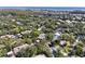 Aerial view of a community with houses and lush green trees at 1106 Lennox W Rd, Palm Harbor, FL 34683