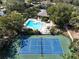 Community pool and tennis court, perfect for recreation at 1106 Lennox W Rd, Palm Harbor, FL 34683