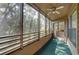 Spacious screened balcony with ceiling fan and sliding door access at 1106 Lennox W Rd, Palm Harbor, FL 34683
