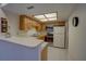 Bright kitchen features wood cabinets, modern appliances, and a breakfast bar at 1106 Lennox W Rd, Palm Harbor, FL 34683